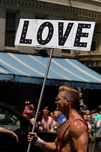 man holding love signage thumbnail