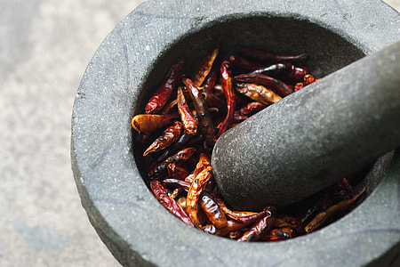 dried chili in gray concrete mortar and pestle thumbnail