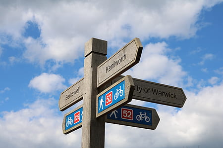 photo of gray road signage under cloudy sky thumbnail