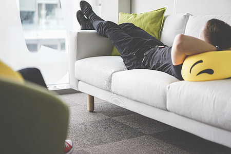 Young Man Napping on White Sofa in the Office thumbnail
