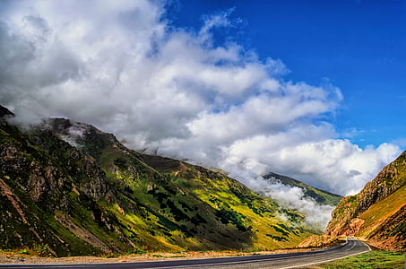 mountain under white clouds at daytime thumbnail