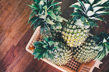 pineapples in pink plastic basket thumbnail