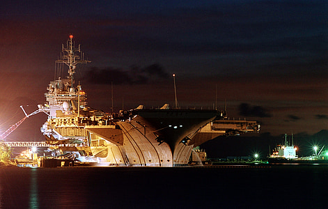 gray aircraft carrier at night thumbnail
