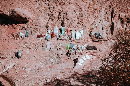 aerial photography of clothes on rock boulders at daytime thumbnail