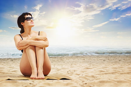 woman in black bikini sitting on brown sand thumbnail
