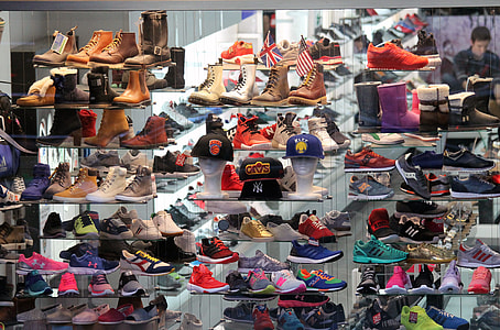 assorted-color shoes on clear glass rack thumbnail
