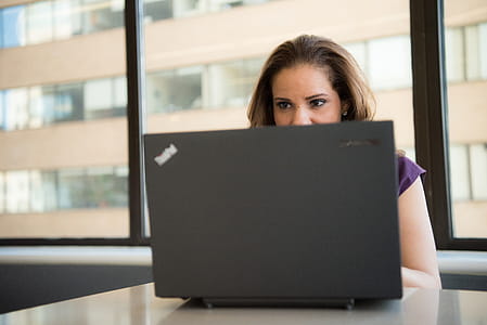 Woman Wearing Purple Top in Front of Lenovo Thinkpad thumbnail