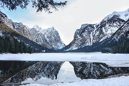 body of water surrounded with mountains thumbnail