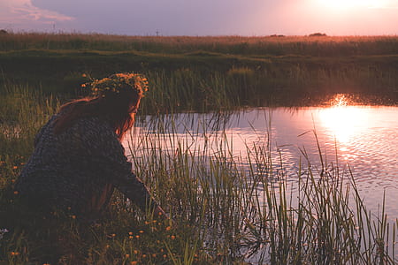 human near pond during golden hour thumbnail