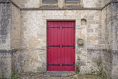 gray brick structure with red wooden door thumbnail