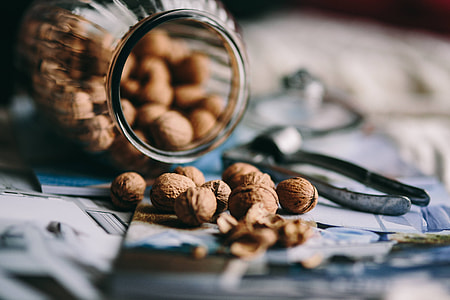 Jar full of walnuts with a fresh healthy shake and musli in a bowl thumbnail