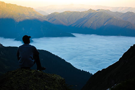 Man on the Edge of the Cliff Above the Cloudy Sky thumbnail