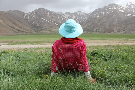 woman sitting facing on mountain thumbnail