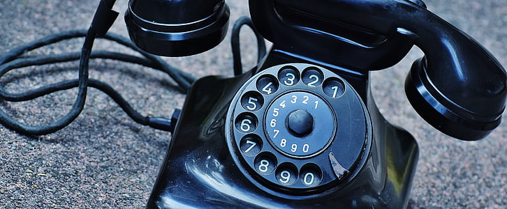 vintage black rotary phone on gray surface thumbnail
