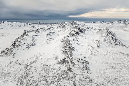 landscape photo of snow-capped mountain under cloudy sky thumbnail