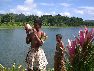 man and boy standing beside body of water thumbnail