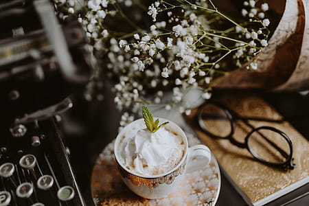 Coffee in a decorative cup with a golden ornament thumbnail