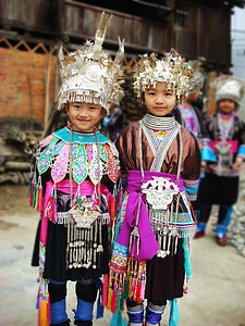 two boy and girl wearing traditional costumes thumbnail
