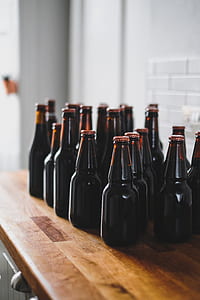 brown glass bottles with red lid lot on brown wooden desk thumbnail