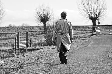 person in coat walking outdoors thumbnail