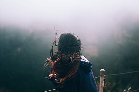 women's in blue hoodie staring down thumbnail