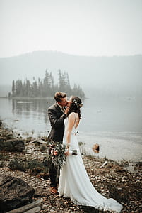 couple wedding kissed near body of water at daytime thumbnail