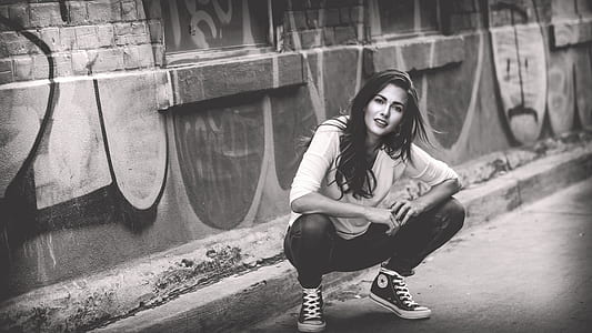 woman squatting on floor near wall thumbnail