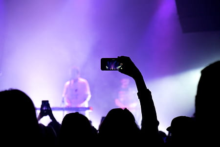 person recording band performance using smartphone thumbnail