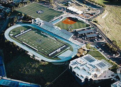 aerial photography of football field near building at daytime thumbnail