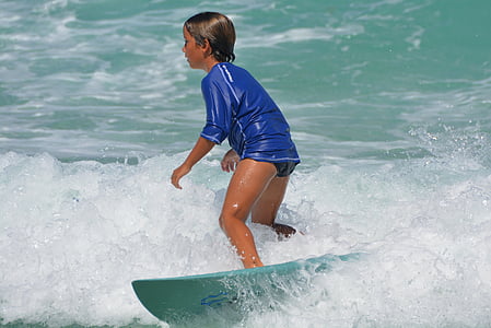 boy riding surfboard during daytime thumbnail