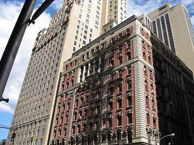 brown and red high-rise building under blue and white sky during daytime thumbnail
