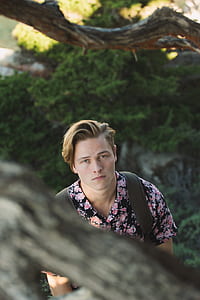 man in pink and black floral shirt thumbnail