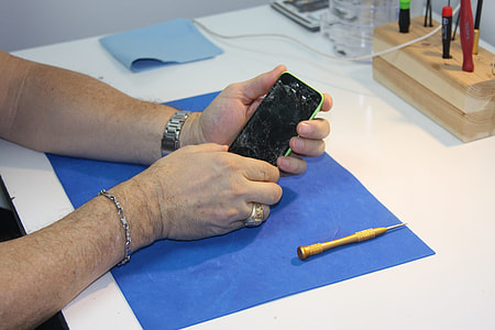 person holding turned off phone on table thumbnail