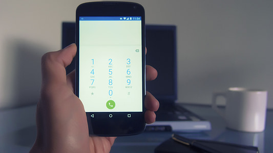 person holds turned on black Android smartphone thumbnail