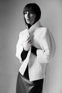 woman in white jacket posing for photo thumbnail