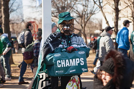 person wearing brown dog mask holding champs poster thumbnail