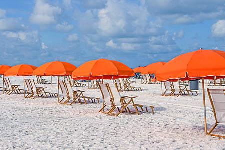 sun loungers with orange umbrellas thumbnail