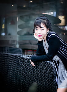 woman leaning on black chair thumbnail