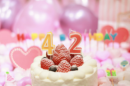 white and red strawberry cake with 42 candle thumbnail