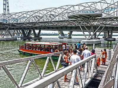 people on pier boarding red boat thumbnail
