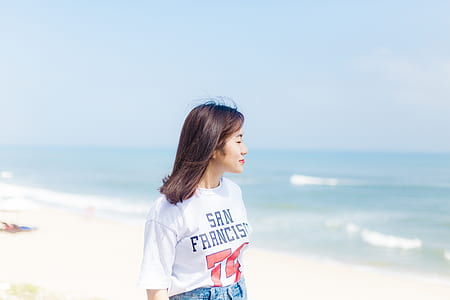 woman standing on seashore at daytime thumbnail
