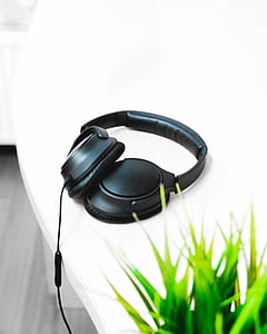black Bose corded headphones on white table thumbnail