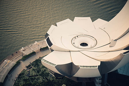 aerial view of white concrete structure beside body of water thumbnail