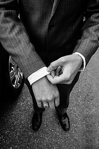 grayscale photography of man in black suit close up photo thumbnail