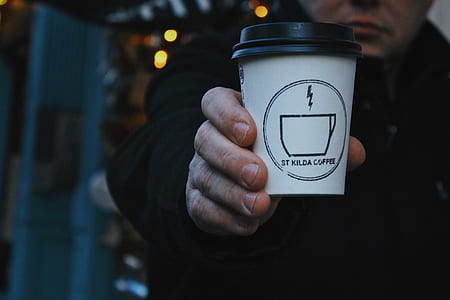 person holding disposable cup thumbnail