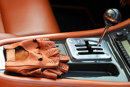 pair of brown leather gloves on gear shift lever thumbnail