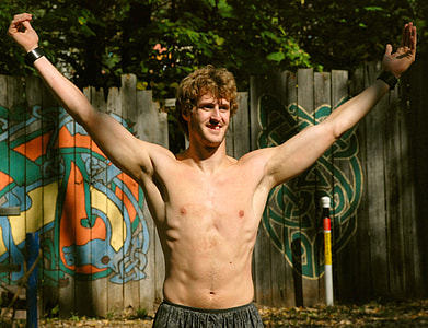 man half-naked raising his two arms thumbnail