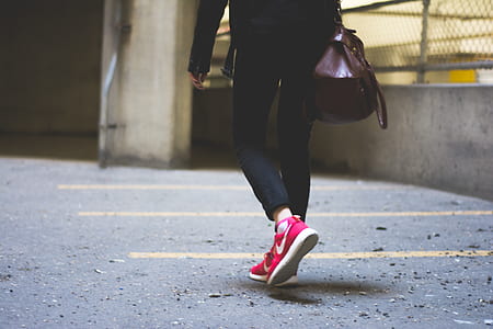 woman walking on road near fence thumbnail