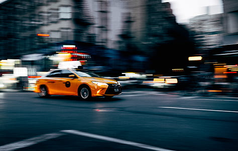 time lapse photography of orange Toyota Camry sedan on road thumbnail