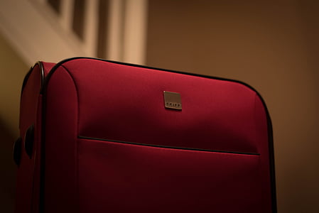 red and black luggage bag thumbnail